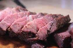 Closeup of beef sirloin tip roast cut up into steaks