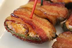 Cream cheese stuffed jalapenos wrapped in bacon