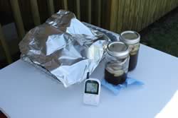 Close up of themometer, iced tea and foil pan