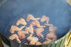 Chicken hot wings on bottom grate of WSM